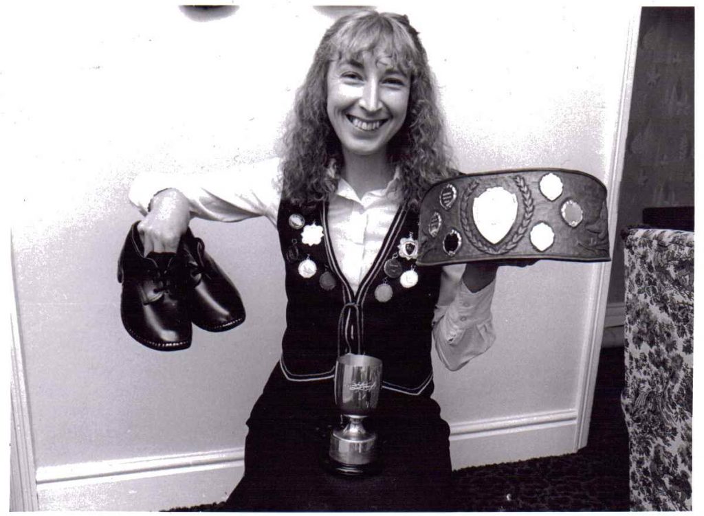 Photo of Lynette with belt and cup for local paper, August 1982